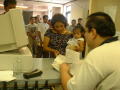 Thumbnail image of item number 1 in: '[Woman holding small child at counter]'.