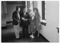 Photograph: [Tom Kreneck and group looking at a document]