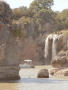 Photograph: [Tour boat beside a double waterfall]