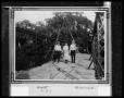Photograph: [Three Individuals on the Tres Palaicios Swing Bridge]