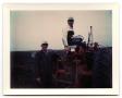 Photograph: [Carl and Curtis Jensen Working with a Tractor on Their Farm]