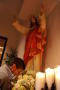 Primary view of [Parishioner prays under statue of Jesus]