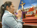 Photograph: [Woman prays in front of alter]