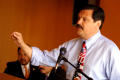 Primary view of [Domingo Garcia speaking into microphone with arm raised]