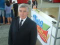 Photograph: [Arturo Violante standing in front of Viva Dallas sign]