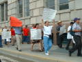 Primary view of [Signs in Spanish and English are carried by protesters]