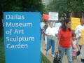 Photograph: [Protesters march past the Dallas Museum of Art Sculpture Garden]