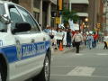 Photograph: [Dallas Police car is in front of a line of protesters]