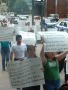 Primary view of [Protesters carry hand made signs in Spanish]