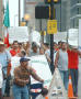 Photograph: [Protesters carry signs and the Mexican Flag]
