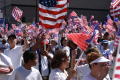 Photograph: [Group of immigration protesters wave American flags]