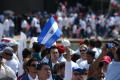 Photograph: [The flag of El Salvador is raised at march]