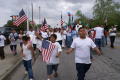 Photograph: [Young protesters marching with flags and signs]