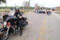 Photograph: [Police officer on motorcycle in front of group of protesters]