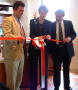 Photograph: [Woman and two men in a ribbon-cutting ceremony]