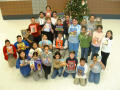 Primary view of [Students and their teacher pose with the books at Seminary Hills Elementary]
