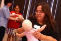 Primary view of [Mothers use dolls to help in first aid training]