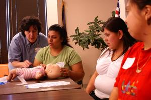 Primary view of object titled '[Mothers take part in an Early Education Program first aid class]'.