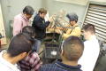 Photograph: [Students gather around for a demonstration during a vocational class]