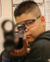 Photograph: [Student takes aim with air rifle]