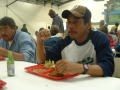 Photograph: [Men eating at tables]