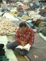 Photograph: [Man sitting on floor reading]