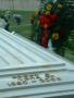 Photograph: [Marble top of Edgar Vera's casket with flowers in background]