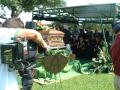 Photograph: [Video camera recording mourners and casket]
