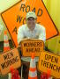 Photograph: [Man with construction signs and traffic cones]