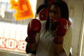 Photograph: [Girl in red boxing gloves with hands raised]