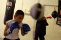 Photograph: [Two students hitting boxing bags]