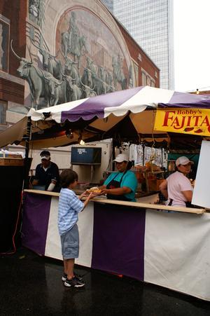 Primary view of object titled '[Boy receiving food from "Bobby's Fajitas" stand]'.
