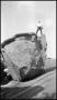 Photograph: [Photograph of a Man Standing on Balanced Rock]