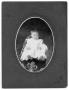 Photograph: [Portrait of unidentified baby in white dress and white shoes]