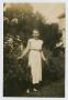 Photograph: [Young Woman Standing in a Bush]