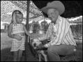 Photograph: [Virge T. "Cowboy" Williams with a Child and a Dog]
