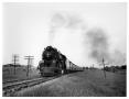 Photograph: [Locomotive rolls through Texas countyside]