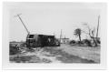 Photograph: [Photograph of Streetcar Overturned in Road]
