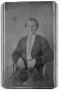 Photograph: [Young man sitting in cane chair]