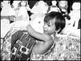 Photograph: [Child Hugging a Doll]