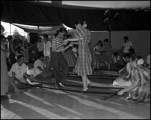 Primary view of object titled '[Festival Visitors Learning Filipino Tinikling]'.