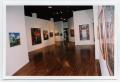 Photograph: [Several Colorful Paintings in a Gallery]