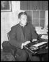 Photograph: [Photograph of a Priest in an Office]