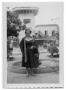 Photograph: [Marie Burkhalter standing in front of a fountain]