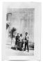 Photograph: Man and two women outside a building
