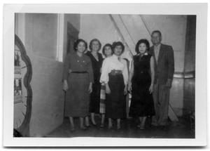 Primary view of object titled 'Five women and a man standing in the back of a corridor'.