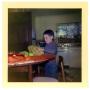 Photograph: Boy at a table opening a package