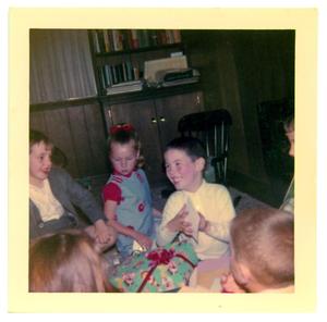 Primary view of object titled 'Child sitting in a group about to read a card'.