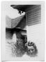 Photograph: Woman standing outside of a house