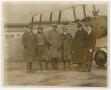 Photograph: [Group of men by plane]